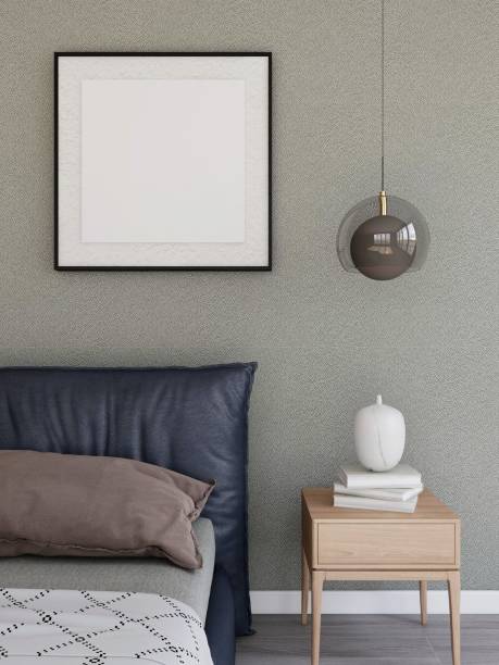 istock Bedroom with a square frame mockup, a large bed, a nightstand with books and a lamp 2198912049