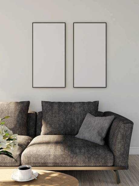 istock Living room with two blank vertical frame mockups, gray sofa, table with cup of coffee and ornamental plant 2198912071