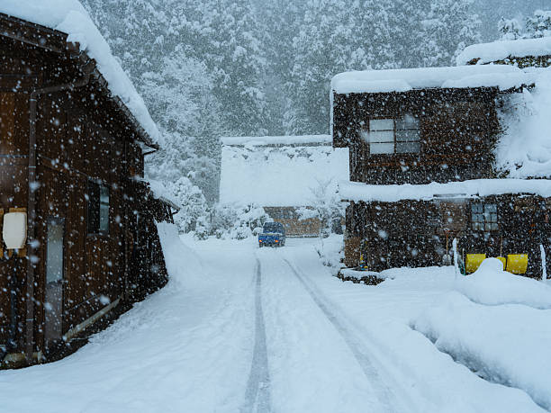 Scenic view of cute quaint houses in Shirakawa-go in blizzard , Japan