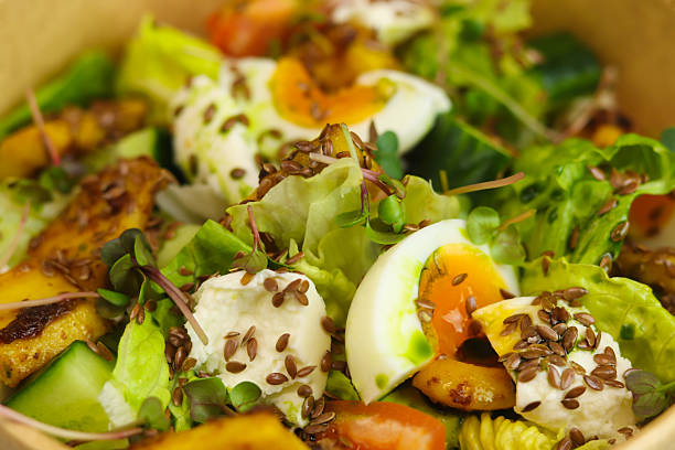 istock Healthy bowl with fried squid, egg, tomatoes, cucumbers, lettuce, cream cheese 2198915189