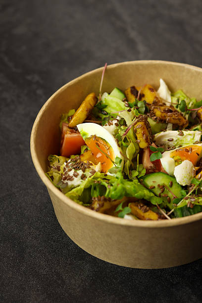 istock Healthy bowl with fried squid, egg, tomatoes, cucumbers, lettuce, cream cheese 2198915190
