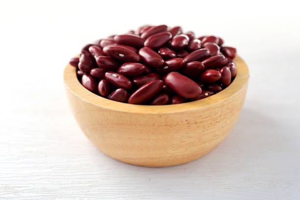Red kidney bean, in a bowl, isolated on white background