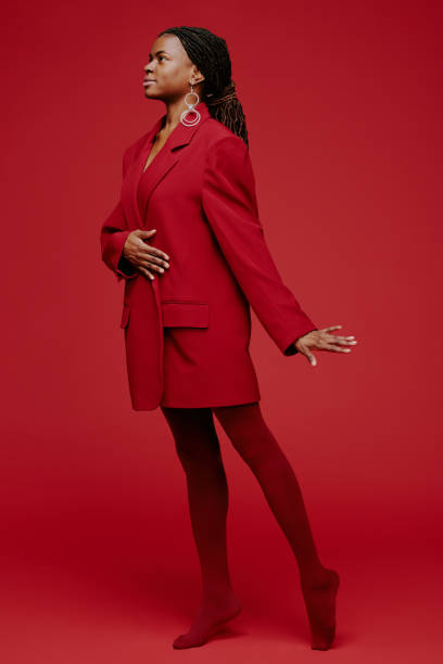 istock Woman Posing Gracefully in Red on Matching Background 2198919917