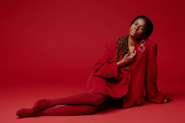 istock Posing Against Red Background in Stylish Red Outfit 2198919952