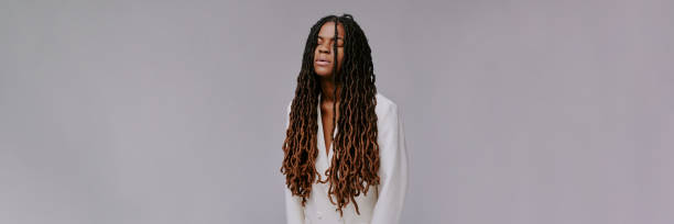 istock Meditating Person with Long Dreadlocks in White Shirt 2198922011