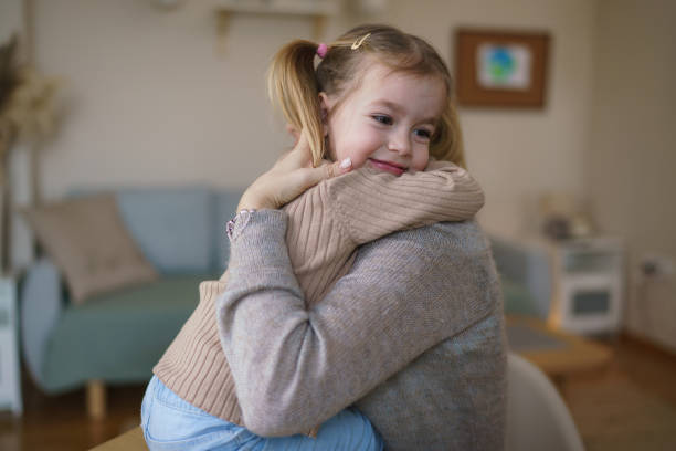 istock Mother and daughter embracing at home 2198922792