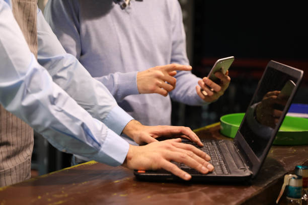 A close-up of a waiter's hands behind the bar