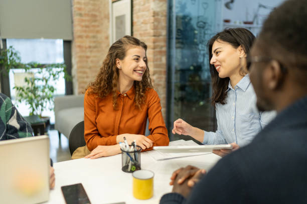istock Group of work colleagues on a meeting at their company 2198925663