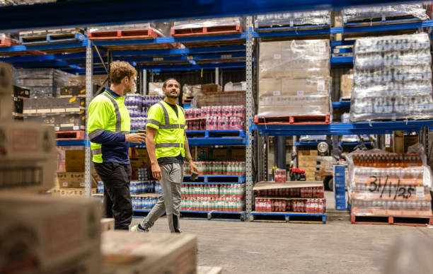 istock Men examining inventory in a distribution warehouse in Sydney, Australia while ensuring safety procedures are followed 2198927930