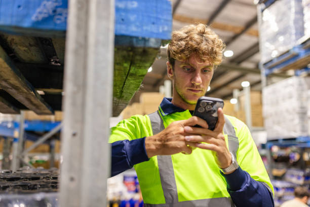 istock Men working in a distribution warehouse in Sydney, Australia, examining logistics and inventory on mobile device 2198928184