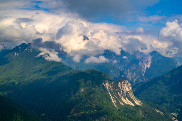 View from the Monte Ponta in the Dolomites in Italy durin a beautiful springtime day with clouds over the mountains.