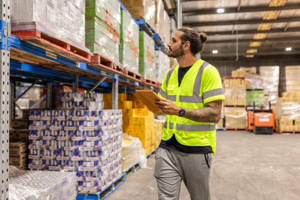 istock Men examining merchandise in a distribution warehouse in Sydney, Australia 2198928466