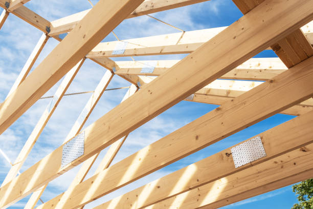 istock Construction of a Wooden Roof Frame Under a Blue Sky 2198928657