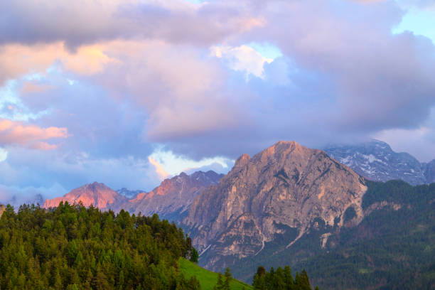 Clouds over the mountain peaks in the Dolomites Italy during a beautiful springtime sunset near Cortina D'Ampezzo.