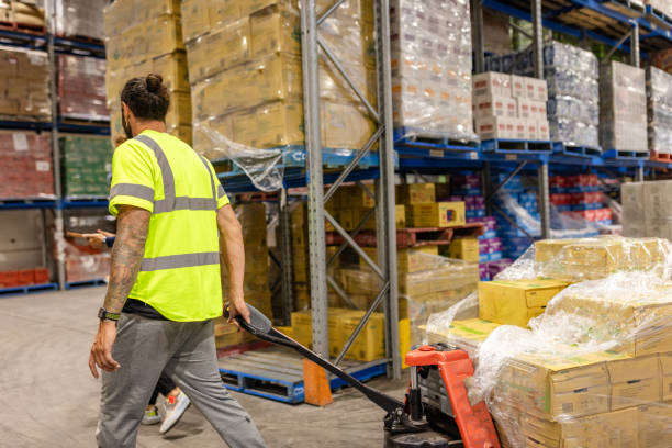 istock Men working in distribution warehouse in Sydney, Australia, managing merchandise and equipment for e-commerce business 2198930468