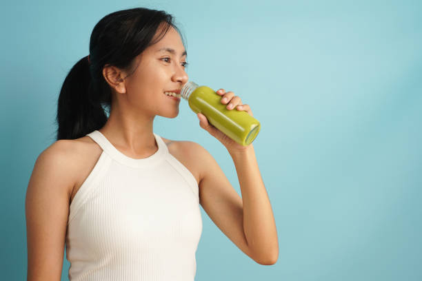 istock Nutritious and Delicious: Woman Enjoying an Avocado Juice 2198930614