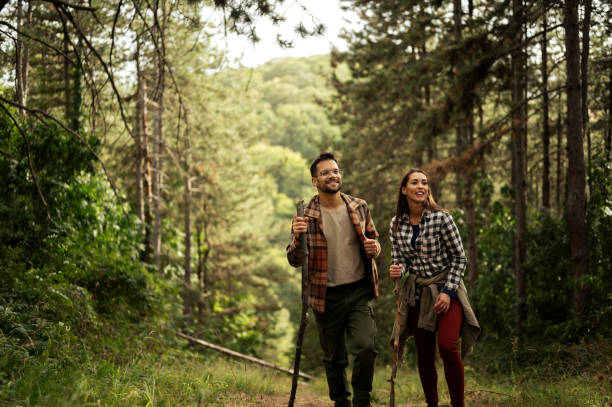 istock Young couple walking through the forrest and exploring nature 2198930728