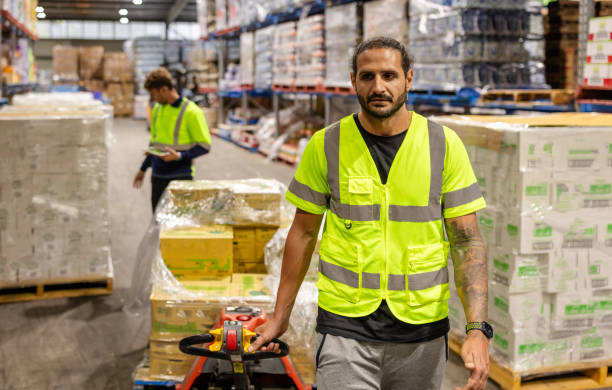 istock Employees working in a busy distribution warehouse in Sydney focused on packaging and shipping operations 2198930833