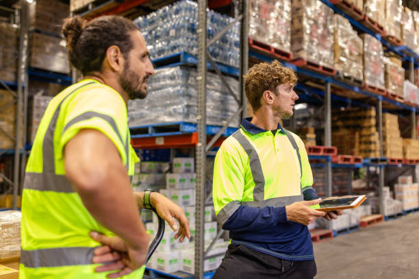 istock Professionals examining inventory in a busy distribution warehouse in Sydney, Australia during work hours 2198930975
