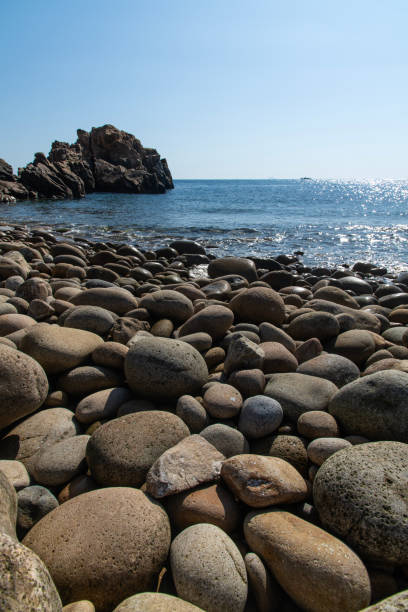 istock pebble beach and sea horizon 2198931106