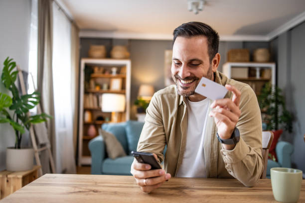 istock Man holding a payment card making an online purchase or checking account balances via electronic banking 2198931435