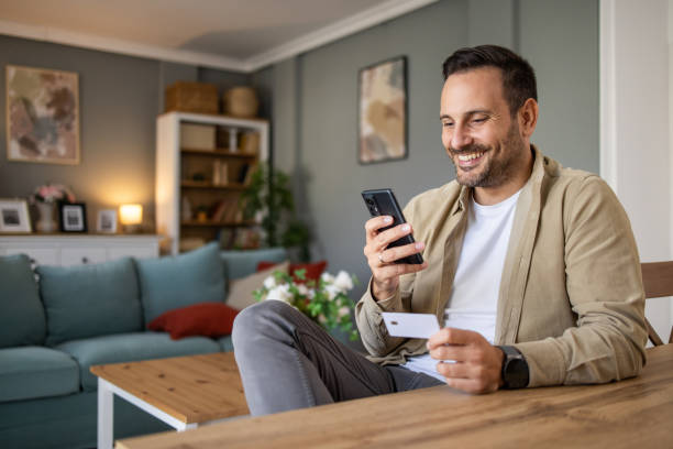 istock Man holding a payment card making an online purchase or checking account balances via electronic banking 2198931464