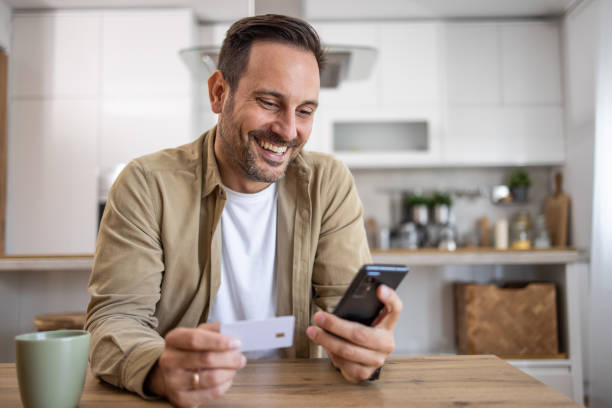 istock Man holding a payment card making an online purchase or checking account balances via electronic banking 2198931551