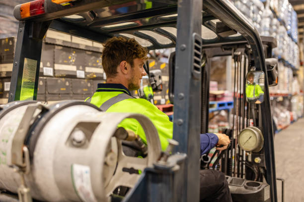 istock Men working with forklifts in a distribution warehouse in Sydney, Australia for e-commerce operations 2198931570