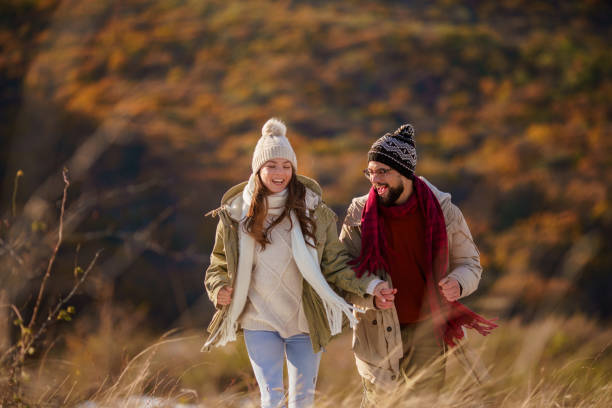 istock Couple holding hands while running in the nature 2198931996