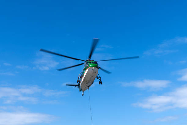 istock helicopter flying in the blue sky 2198932008