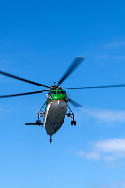 istock helicopter flying in the blue sky 2198932039