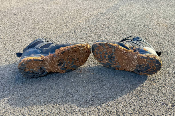 istock Muddy shoes after hiking on a wet trail 2198932122