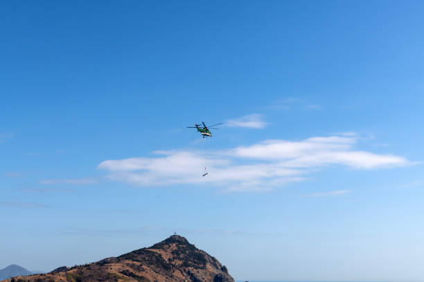 istock helicopter flying on the island 2198932502
