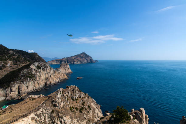 istock helicopter flying on the island 2198932503