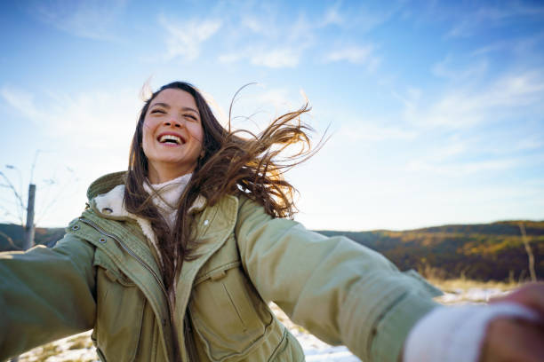 istock Carefree woman spinning in nature 2198933082