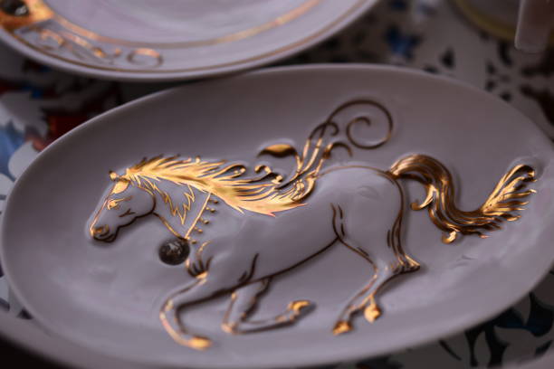 A decorative plate featuring a golden horse motif.