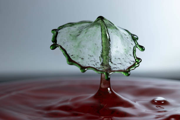 abstract picture with colored drop of various shapes, blurred background, water drop splash, close focus, grainy water texture