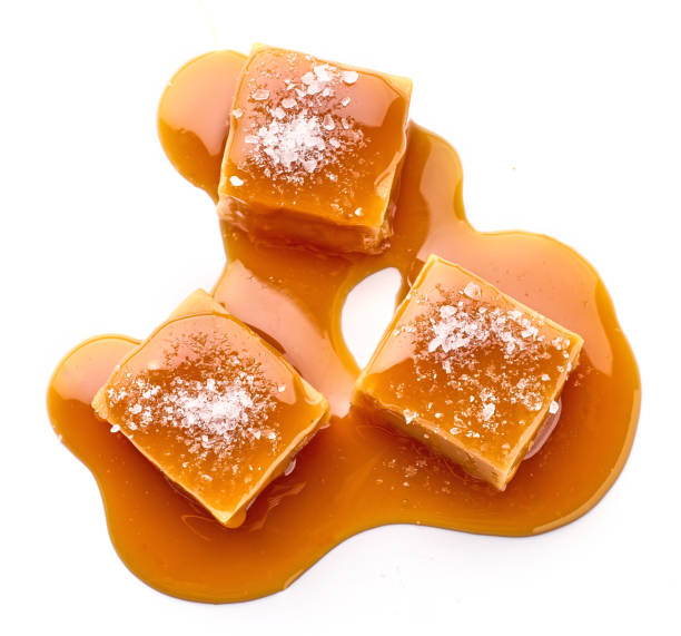 istock salted caramel candy in melted caramel sauce isolated on white background, top view 2198934854