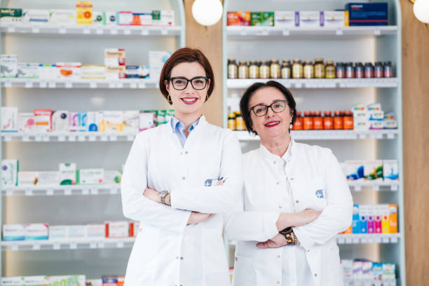 istock Two female pharmacists posing in a drugstore. 2198935778
