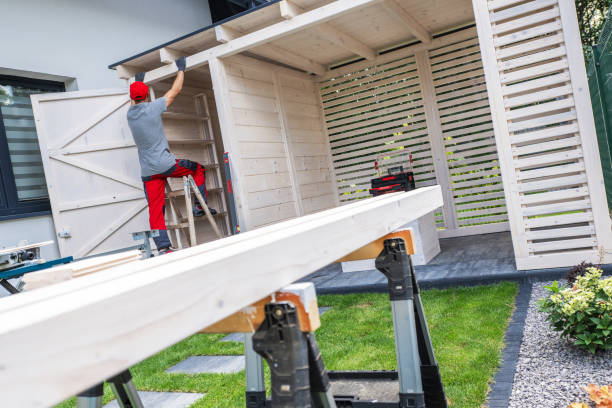 istock Building a Wooden Shed in a Backyard During a Sunny Afternoon With a Skilled Worker on a Ladder 2198936373