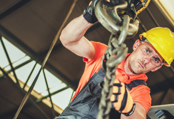 istock Worker in Safety Gear Operating Heavy Machinery in Industrial Setting 2198936966
