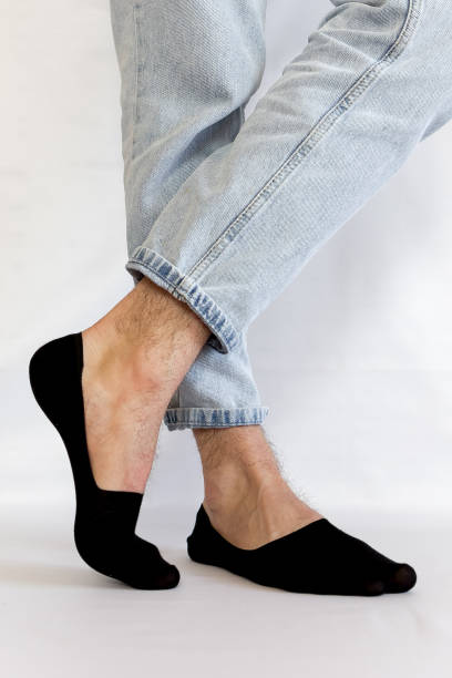 istock Male legs in black short summer socks on a background 2198937502