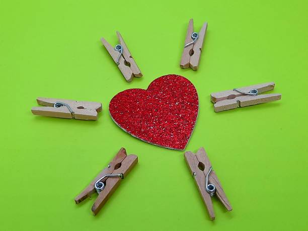 Red heart shape with small wooden clothespins