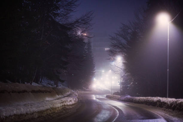 istock Difficult foggy and snowy night time for driving 2198940975