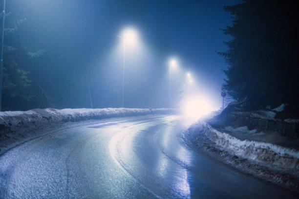 istock Driving in difficult foggy and snowy night 2198941098