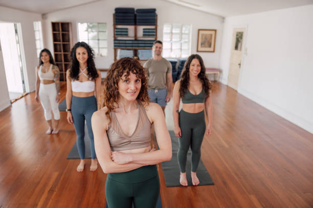 istock Yoga instructor smiling at camera with her team 2198941312