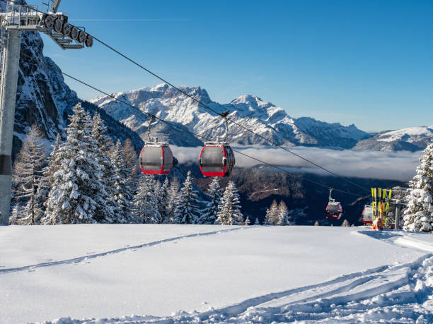 istock Skiing on the Dolomites Civetta resort on a beautiful sunny day. Two gondolas going from Aleghe to the top of the mountain.Italy 2198941396