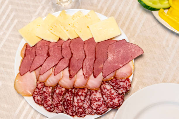 Shot of the table set up with assorted cut fresh vegetables, cold cuts, olives, salads.