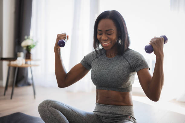 istock Fit African American woman lifting weights 2198943711