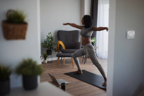 istock Woman in a yoga warrior pose 2198943989